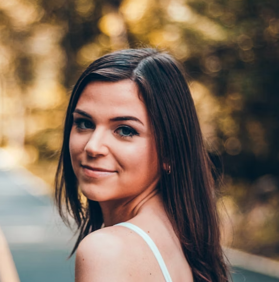 Woman in white top with warm lighting